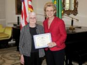 Office of the Governor
Gov. Chris Gregoire presents Phyllis Burger of Ridgefield with a Governor's Volunteer Service Award last month in Olympia.