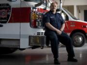 Washougal Fire Capt. Larry Saari sits on a Camas fire engine Friday inside Camas Fire Station 42.