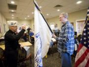 Photos by Steven Lane/The Columbian
Local and national Pearl Harbor survivor associations closed down at end of 2011. Local survivor George Bennett, left, also a national officer, hands over Vancouver chapter funds and paperwork to Marc Lacy, president of Pacific Northwest Sons and Daughters of Pearl Harbor Survivors, on Friday.