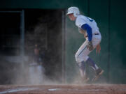 Mountain View's Dean Taylor jumps back to his feet after sliding in to home to score Mountain View's first run in a three-run second inning againt Decatur.