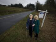 Mabel Parvi, left, poses for a portrait Friday with her friend and real estate agent Karen Lang next to 10 acres of land she owns in Ridgefield.