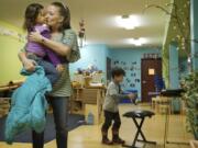 Rachel Collins picks up her daughter, 4-year-old Alexis, at Y's Care, the on-site child care program run by the YWCA Clark County. Y's care is affordable to low-income families and allows single moms, such as Collins, to work.