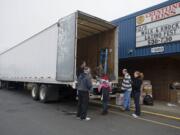 Volunteers at Crestline Elementary in east Vancouver pause to catch their breath Saturday after several hours of loading boxes of donated food during the annual Walk &amp; Knock food drive.