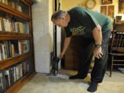 Retired professor John Koroloff points out a ventilation pipe installed in his basement to help reduce radon levels in his home in Vancouver.