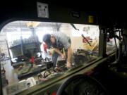 Carl Murdock changes a water pump Tuesday in a Humvee at the new Armed Forces Reserve Center in Sifton, east of Orchards.