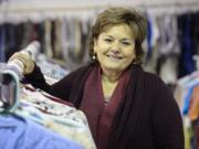 Denise Currie, founder of the Giving Closet, stands among racks of clothing at the nonprofit. &quot;I empty my closet all the time,&quot; she said.