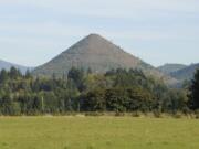 Clark County's cone-shaped Tumtum Mountain is still for sale, according to Terri Eklund, a Vancouver real estate agent who is listing the site.