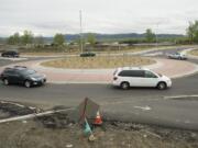 Cars navigate one of the new roundabouts that are part of the Highway 14 widening project in Camas and Washougal.