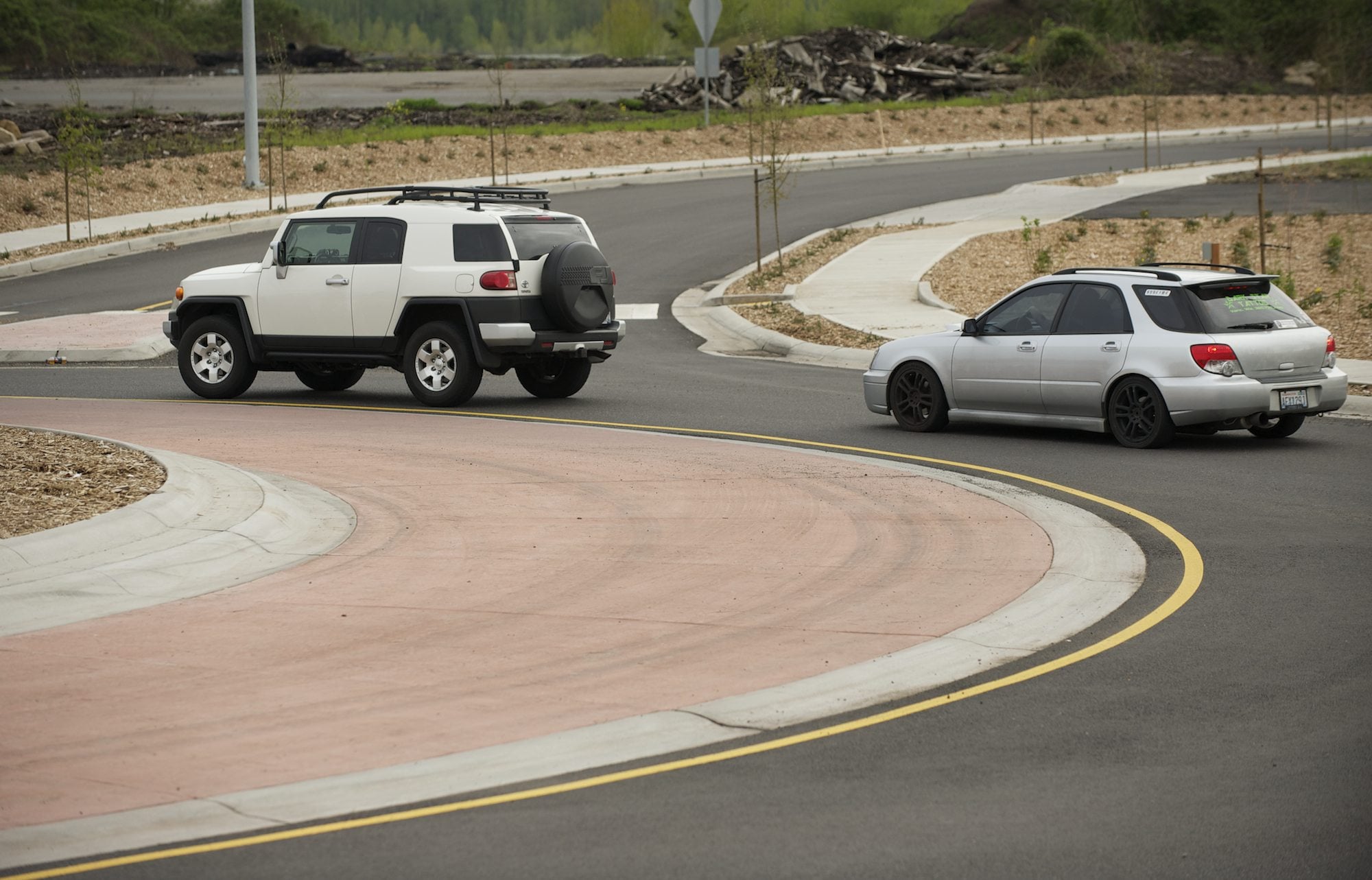 Cars navigate a new roundabout Friday on Hwy.