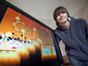 Eli Aldinger, 16, of Vancouver, shows off his video game &quot;New World.&quot; Designing the game made Aldinger a winner in the National STEM Video Game Challenge.