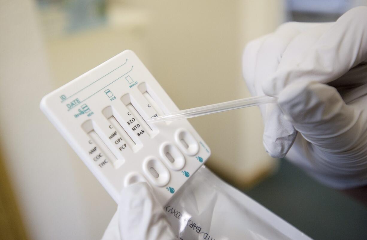 Jennifer Rossiello shows a 10 panel quick check used for identifying controlled substances in a urine sample.