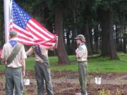 Maple Tree: David Zak, from left, Shawn Sadler and Sean Flynn raise the flag at the rose garden.