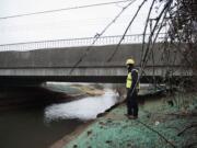 Justin Johnson, inspector for the Clark County Public Works Department, looks over the finished Fifth Plain Creek Bridge on Tuesday.