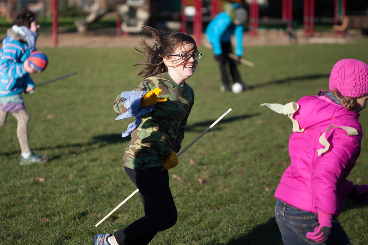 Seeker Lila Redman, center, chases Golden Snitch Allison Kane -- see those golden ribbons on Allison&#039;s pink coat? -- in Ridgefield&#039;s Davis Park on Saturday.