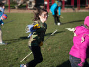 Seeker Lila Redman, center, chases Golden Snitch Allison Kane -- see those golden ribbons on Allison&#039;s pink coat? -- in Ridgefield&#039;s Davis Park on Saturday.