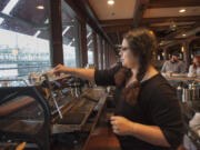 Barista Chiara Caballero prepares an espresso at the new Torque coffee location in the former Red Lion Hotel on Vancouver&#039;s waterfront Tuesday.