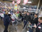 A crowd swarms around the sock tables inside Fred Meyer Salmon Creek as the store opens for Black Friday specials on November 25, 2011.