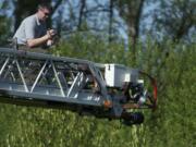 Police used a ladder truck to get a birds eye view while they investigated at the scene where a body was found off Southwest 10th Avenue in Battle Ground on Friday.