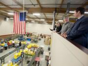 Lucas Reeves, second from right, operations manager of First Aid Only, gives a tour Monday of its facility to Columbia River Economic Development Council officials and Vancouver Mayor Tim Leavitt, right.