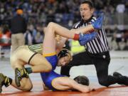 Evergreen's Michael Nguyen has Tahoma's Tim Whitehead all tied up in the 113-pound championship match.