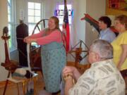 La Center: Barbara Sizemore works the historical museum's Great Spinning Wheel.