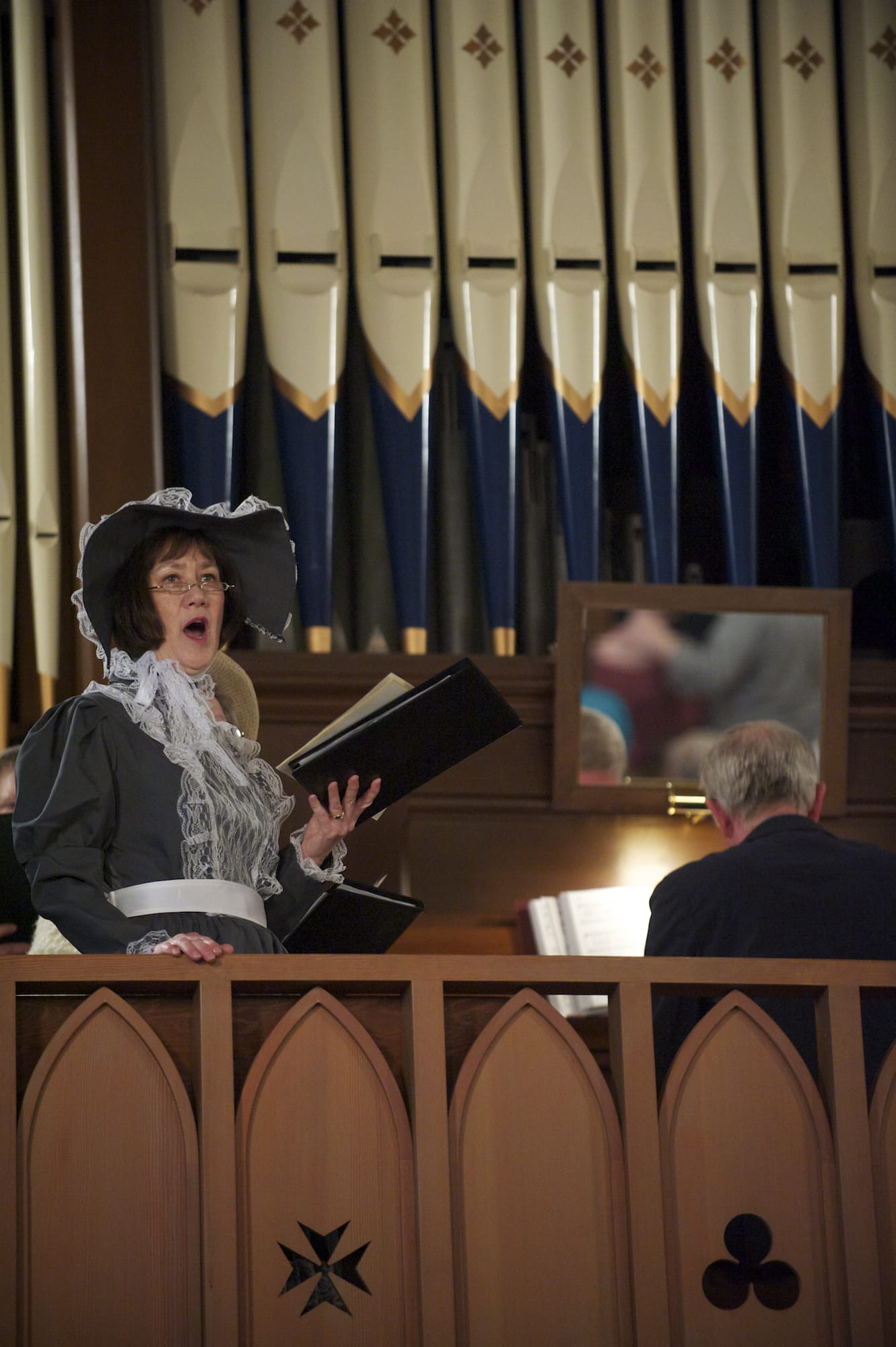 St. Luke's Episcopal Church choir member Pam Goodlett sings from the choir box as the church celebrates its 152nd anniversary on Sunday.