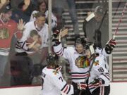 Portland Winterhawks' Ty Rattie, center, celebrates with Joseph Morrow, 7, and Brad Ross, 18, after he scored the game-winner against the Tri-City Americans during the Westernn Conference Playoffs at the Rose Garden.