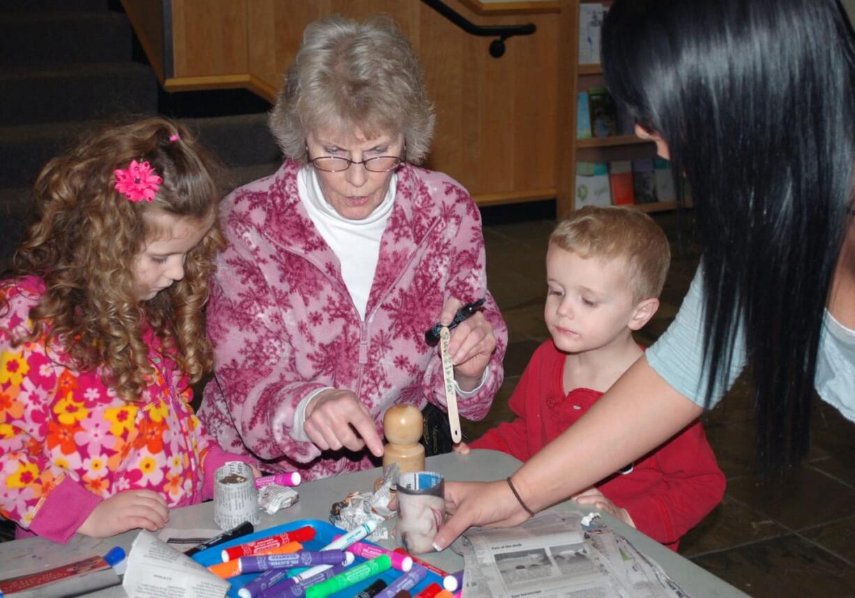 Columbia Way: Norah, Jack and Linda Porter make paper pots and plant seeds for their garden with intern Jessica Salamanca, right, on March 10 at the Second Saturday splash at the Water Resources Education Center.