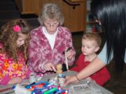 Columbia Way: Norah, Jack and Linda Porter make paper pots and plant seeds for their garden with intern Jessica Salamanca, right, on March 10 at the Second Saturday splash at the Water Resources Education Center.