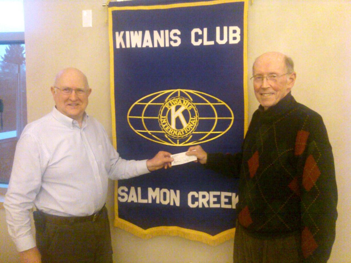 Salmon Creek: Bruce Davis, left, president of Salmon Creek Kiwanis Club, presents check to Bill Coleman of the Clark County Food Bank.