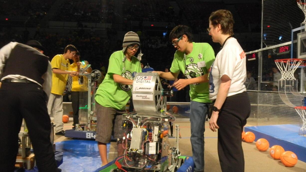 Evergreen: Members of the Green Wrenches put the finishing touch on their hoops-shooting bot.