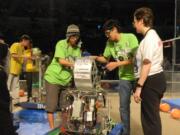 Evergreen: Members of the Green Wrenches put the finishing touch on their hoops-shooting bot.