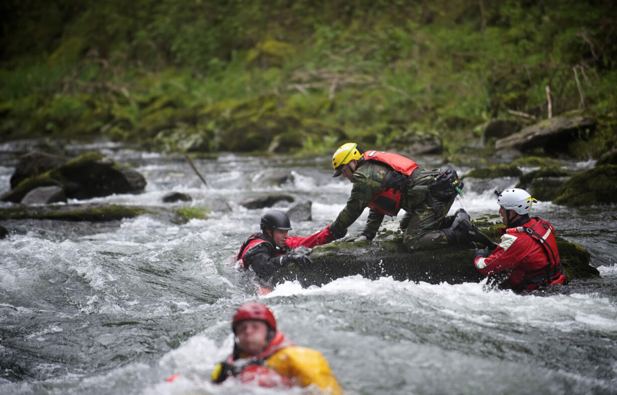 The Region 4 Technical Rescue team conducts water rescue drills at Big Eddy on the Washougal River on April 27.