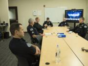 Officer David Krebs, left, listens during a squad briefing Friday afternoon at Vancouver Police Department&#039;s West Precinct. The police chief has proposed adding 42 more officers to the department, which now has 190 officers.