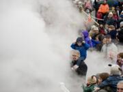 George Powell, 2, and dad Mark Powell, of Vancouver, were engulfed in a cloud of steam from Santa's SP&amp;S 700 steam locomotive as it arrived Saturday morning at the Vancouver Amtrak station.