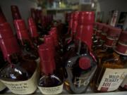 Whiskey bottles sit on a shelf inside the Ridgefield Liquor Store owned by Scott Hughes on Monday.