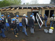 Clark County Skills Center students get some on-the-job training during a home renovation April 30 in the Bagley Downs neighborhood.