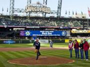 Mark Ray throws the ceremonial first pitch April 14.