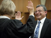 Gregory Gonzales, the newly appointed Superior Court judge, is sworn in Friday afternoon by Clark County Superior Court Presiding Judge Barbara Johnson in her courtroom.