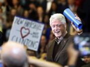 Former President Bill Clinton waves to a cheering crowd as he arrives during a campaign stop for his wife, Democratic presidential candidate Hillary Clinton, in January in Nashua, N.H.