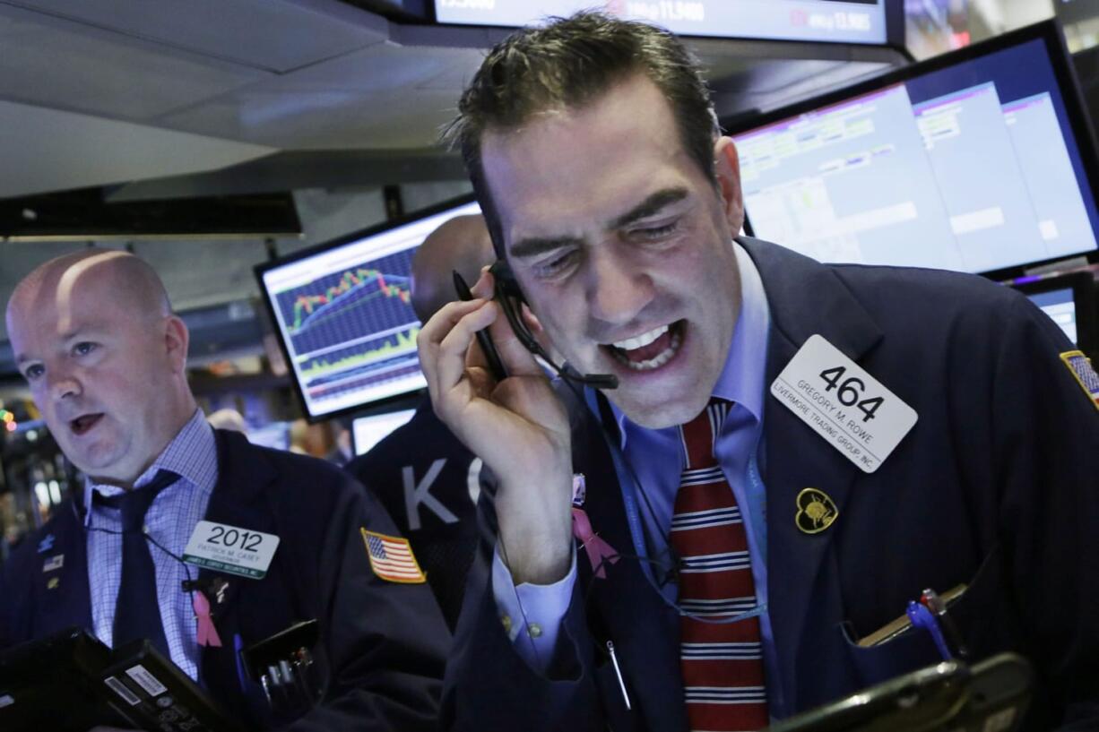 Stock trader Gregory Rowe works Friday at the New York Stock Exchange.