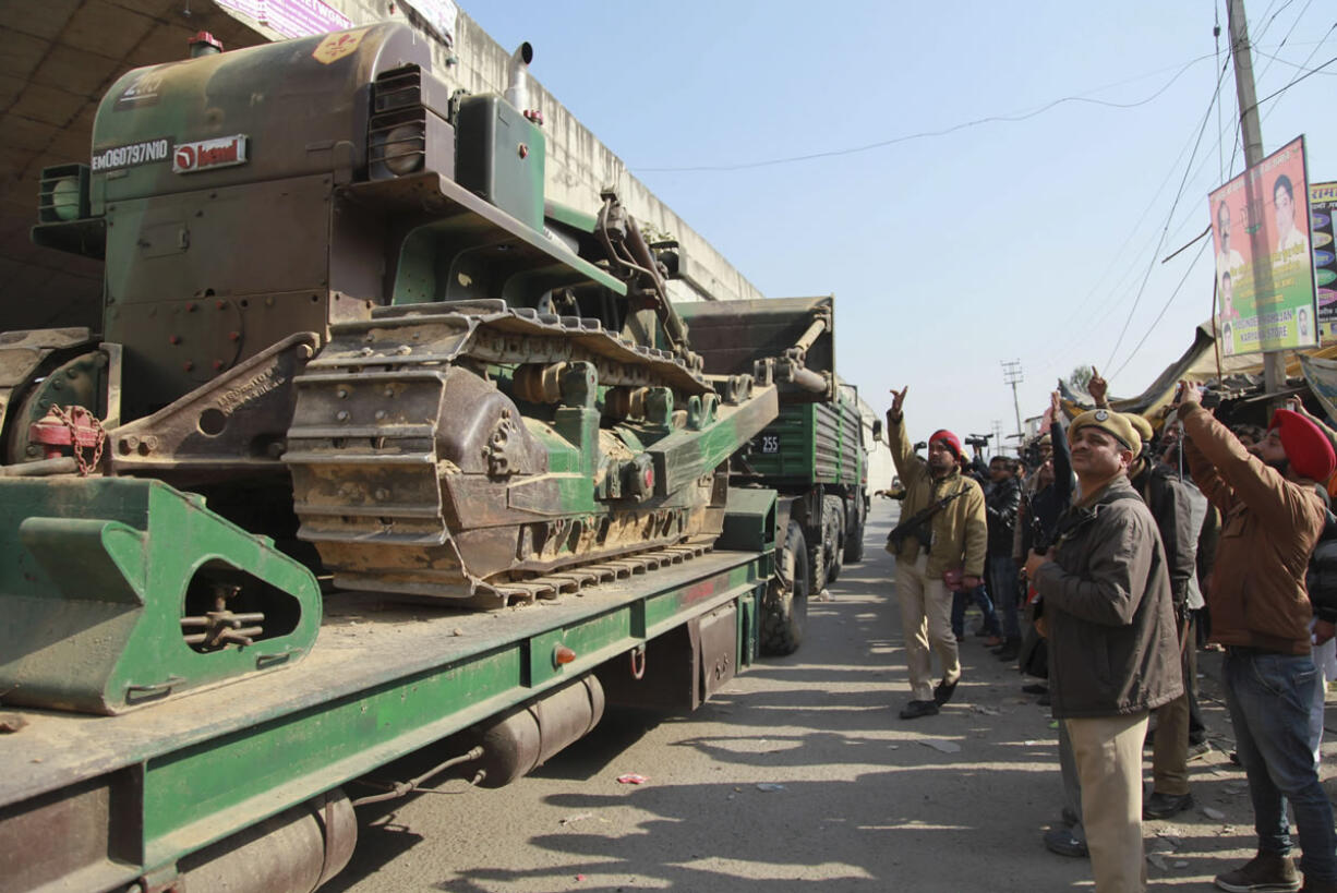 Indian army trucks carrying military equipment arrive Sunday at an air force base in Pathankot, India. The compound came under attack before dawn Saturday.