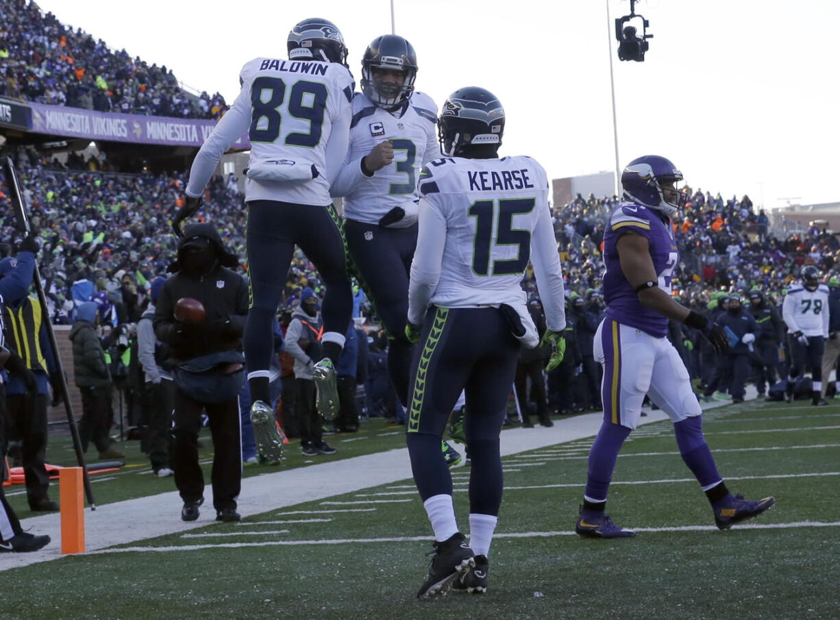 Seattle Seahawks wide receiver Doug Baldwin (89) and quarterback Russell Wilson (3) celebrate a touchdown as wide receiver Jermaine Kearse (15) joins during the second half of an NFL wild-card football game against the Minnesota Vikings, Sunday, Jan. 10, 2016, in Minneapolis. (AP Photo/Nam Y.