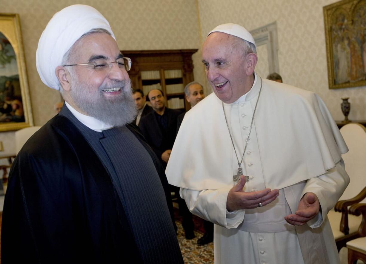 Pope Francis and Iranian President Hassan Rouhani, left, share a laugh during their private audience at the Vatican on Tuesday. Iran&#039;s president has paid a call on Pope Francis at the Vatican during a European visit aimed at positioning Tehran as a potential top player in efforts to resolve Middle East conflicts, including Syria&#039;s civil war.