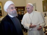 Pope Francis and Iranian President Hassan Rouhani, left, share a laugh during their private audience at the Vatican on Tuesday. Iran&#039;s president has paid a call on Pope Francis at the Vatican during a European visit aimed at positioning Tehran as a potential top player in efforts to resolve Middle East conflicts, including Syria&#039;s civil war.