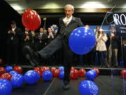 Republican presidential candidate Rep. Ron Paul, R-Texas, kicks balloons from the stage after speaking to supporters following his loss in the Maine caucus to Mitt Romney Feb.