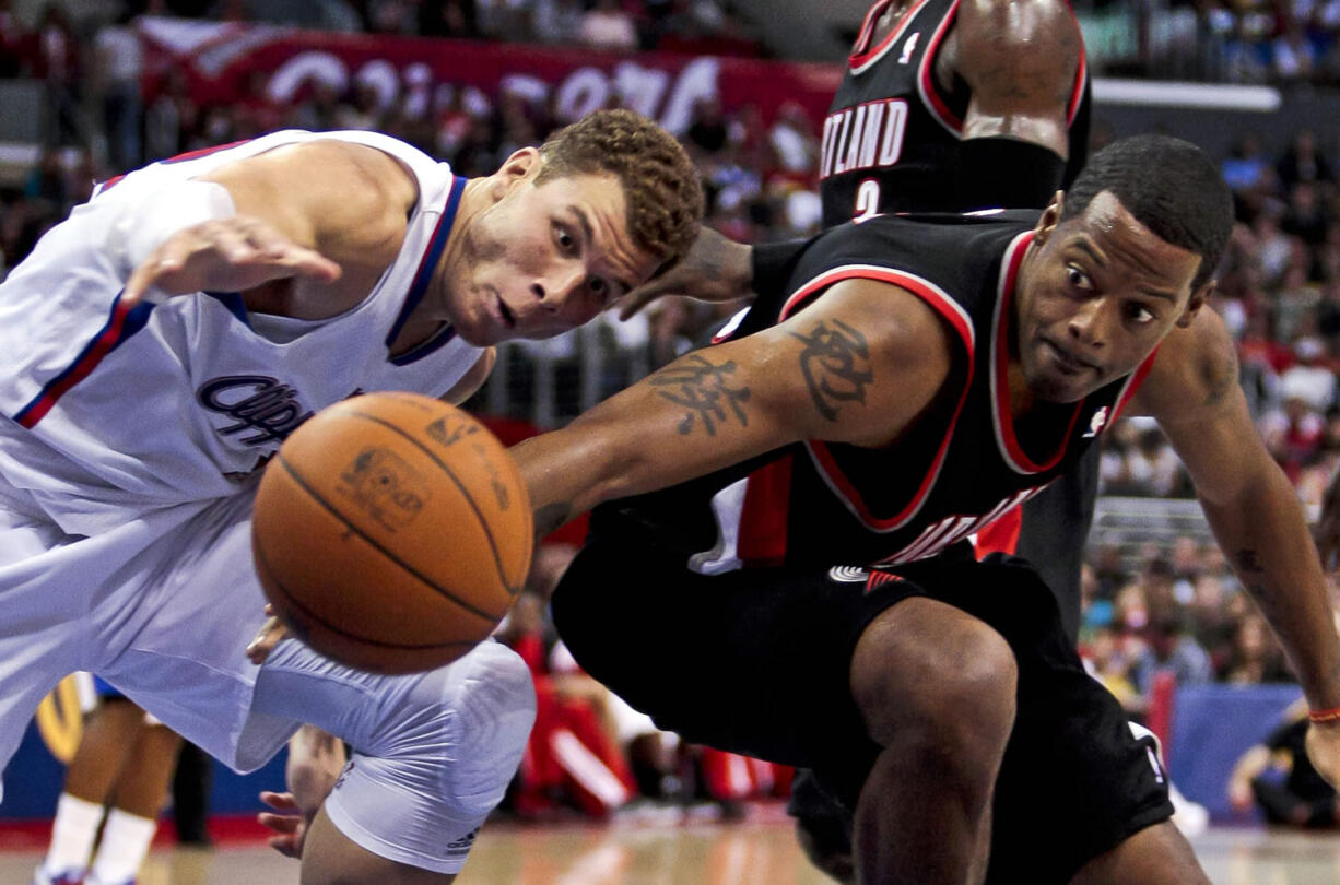 Portland's Marcus Camby, right, and Los Angeles Clippers' Blake Griffin reach for a loose ball during the first half Sunday.