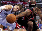 Portland's Marcus Camby, right, and Los Angeles Clippers' Blake Griffin reach for a loose ball during the first half Sunday.