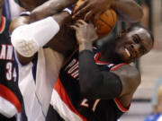 Dallas Mavericks center Brendan Haywood (33) and Portland Trail Blazers forward J.J. Hickson (21) battle for a rebound during the first half of an NBA basketball game on Friday April 6, 2012, in Dallas.