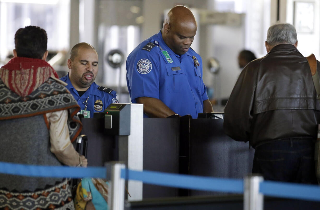 FILE - In this Nov. 25, 2015 file photo, Transportation Security Administration agents check travelers identifications at a security check point area in Terminal 3 at O&#039;Hare International Airport in Chicago. Fliers who don&#039;t have the latest driver&#039;s licenses will have a two-year reprieve before their IDs are rejected at airport security checkpoints. Many travelers had been worried that the Transportation Security Administration would penalize them because of a federal law requiring the more-stringent IDs at the start of this year. (AP Photo/, File) (Nam Y.